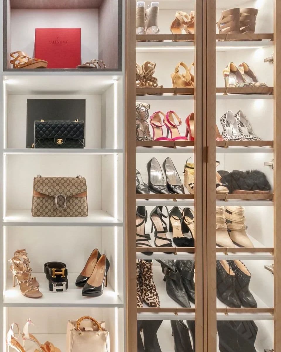 Lit display closet with jewelry cabinet, designer handbags, and a shoe wall