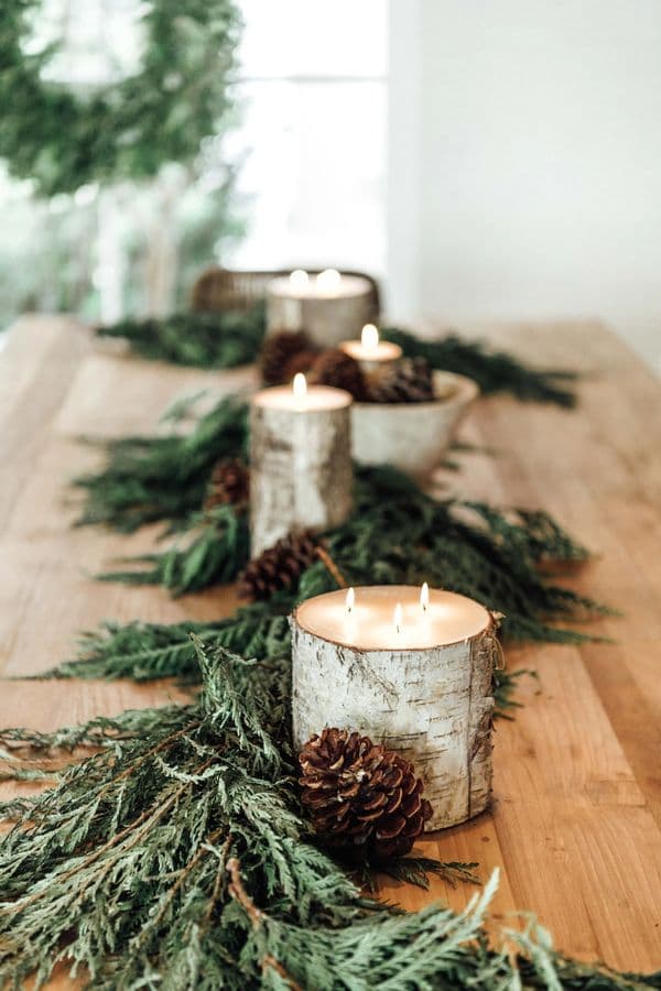 Birch candles and cedar garland on a wood table