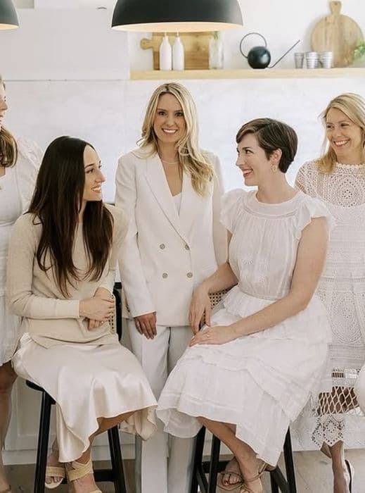 B. Moore team members in white, laughing together in a kitchen