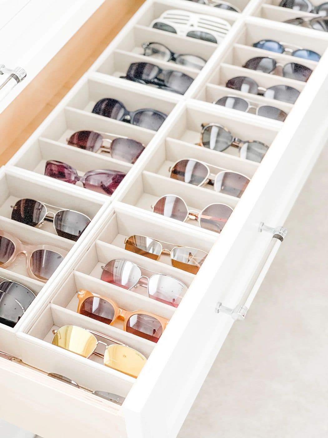 Drawer of sunglasses in white compartment organizers
