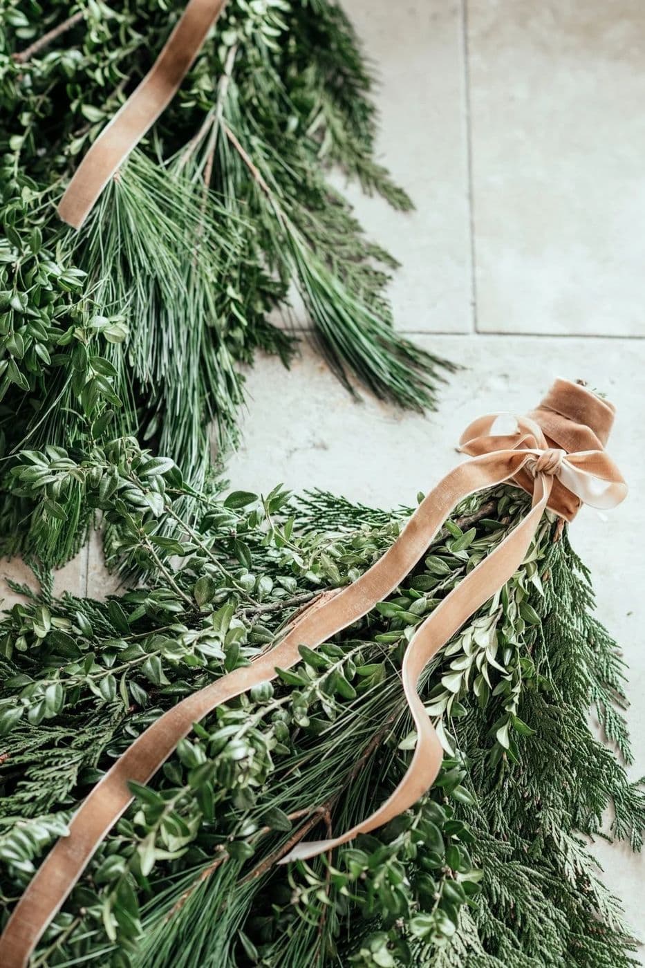 Evergreen garland tied with a blush velvet ribbon
