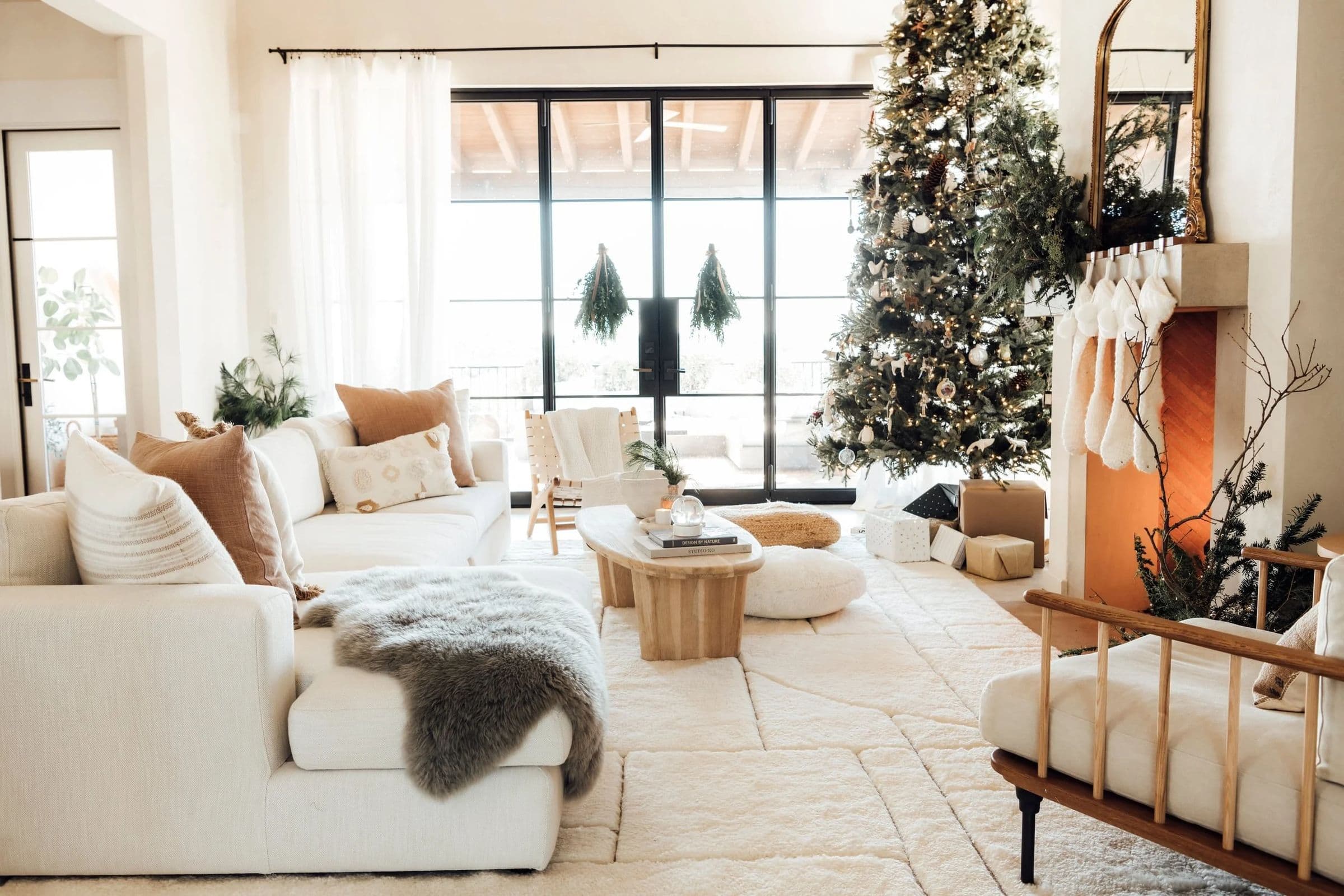 Living room styled for the holidays with a decorated tree and stockings