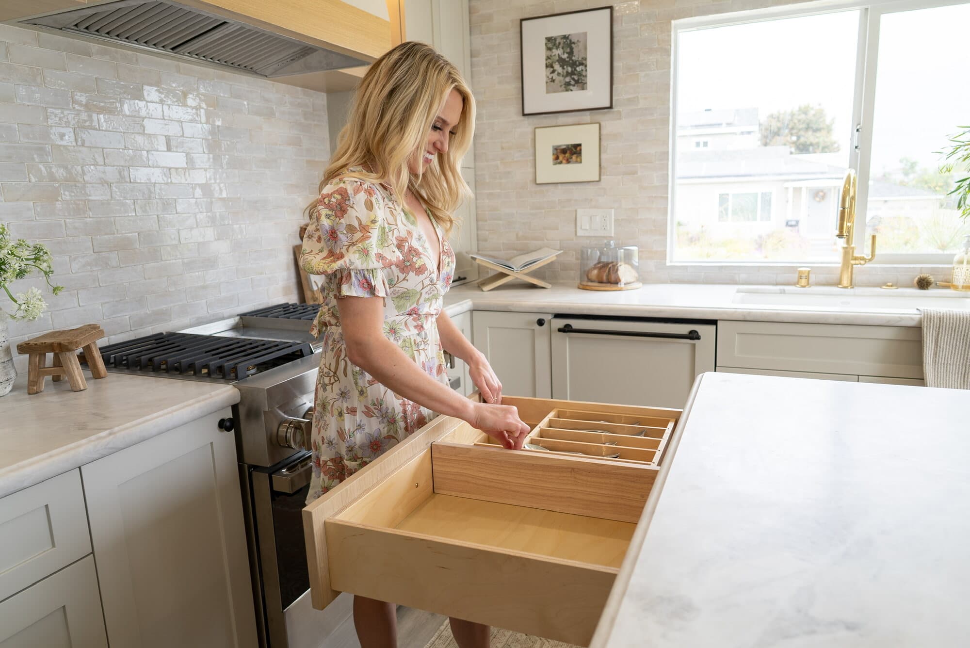 Organized kitchen drawer fitted with custom wooden dividers and inserts